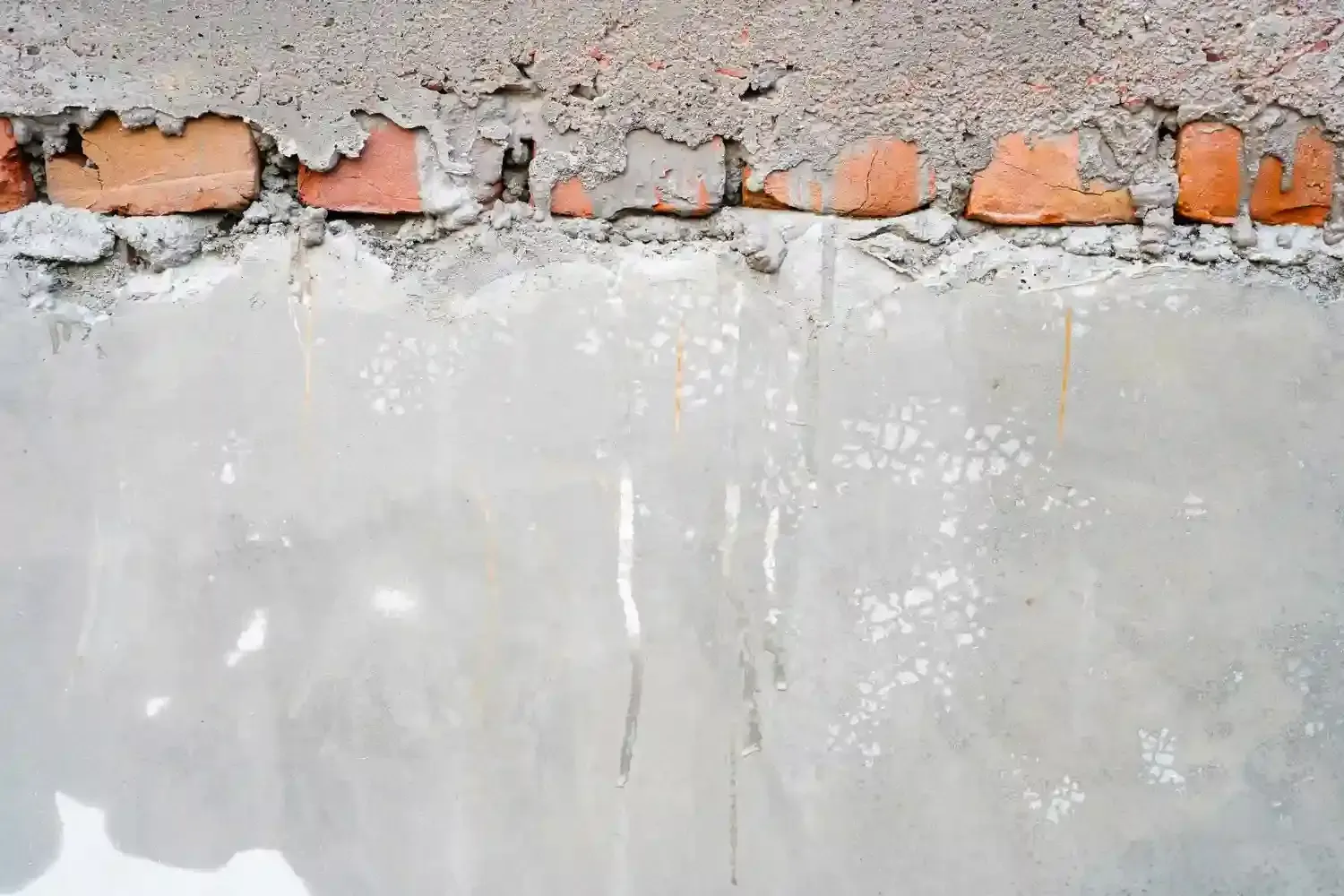 Below grade concrete foundation wall showing where the structure sits beneath ground level, illustrating what does below grade mean in foundation construction