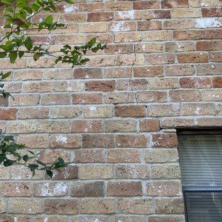 Crack in brick exterior wall of home due to foundation damage