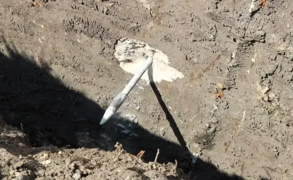 Foundation pier anchor secured deep in the soil to support and stabilize a settling structure.