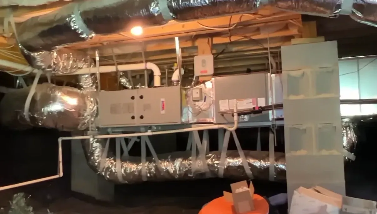HVAC units and flexible ductwork installed in an encapsulated crawl space alongside crawl space dehumidifiers for year round moisture control