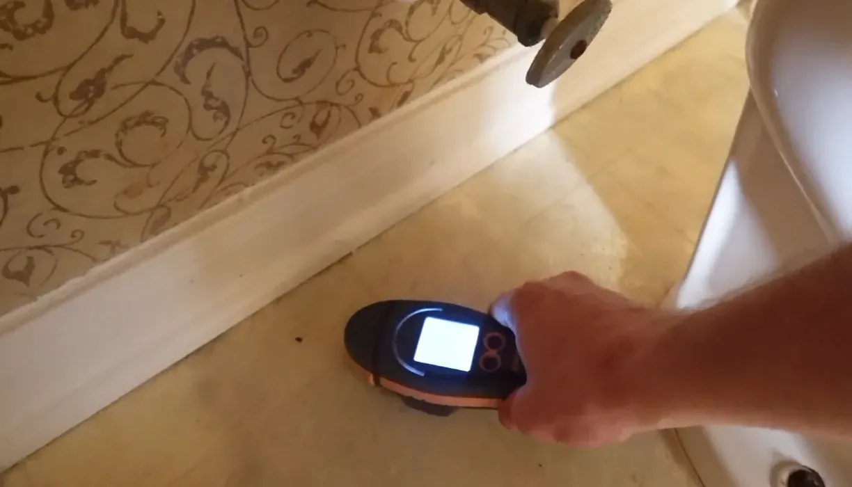 Inspector checking floor slope when buying a house with foundation issues