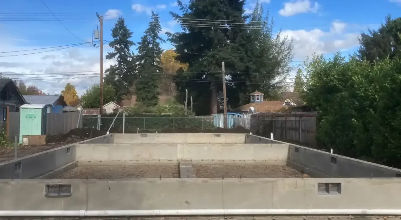 New concrete foundation walls prepared for residential construction
