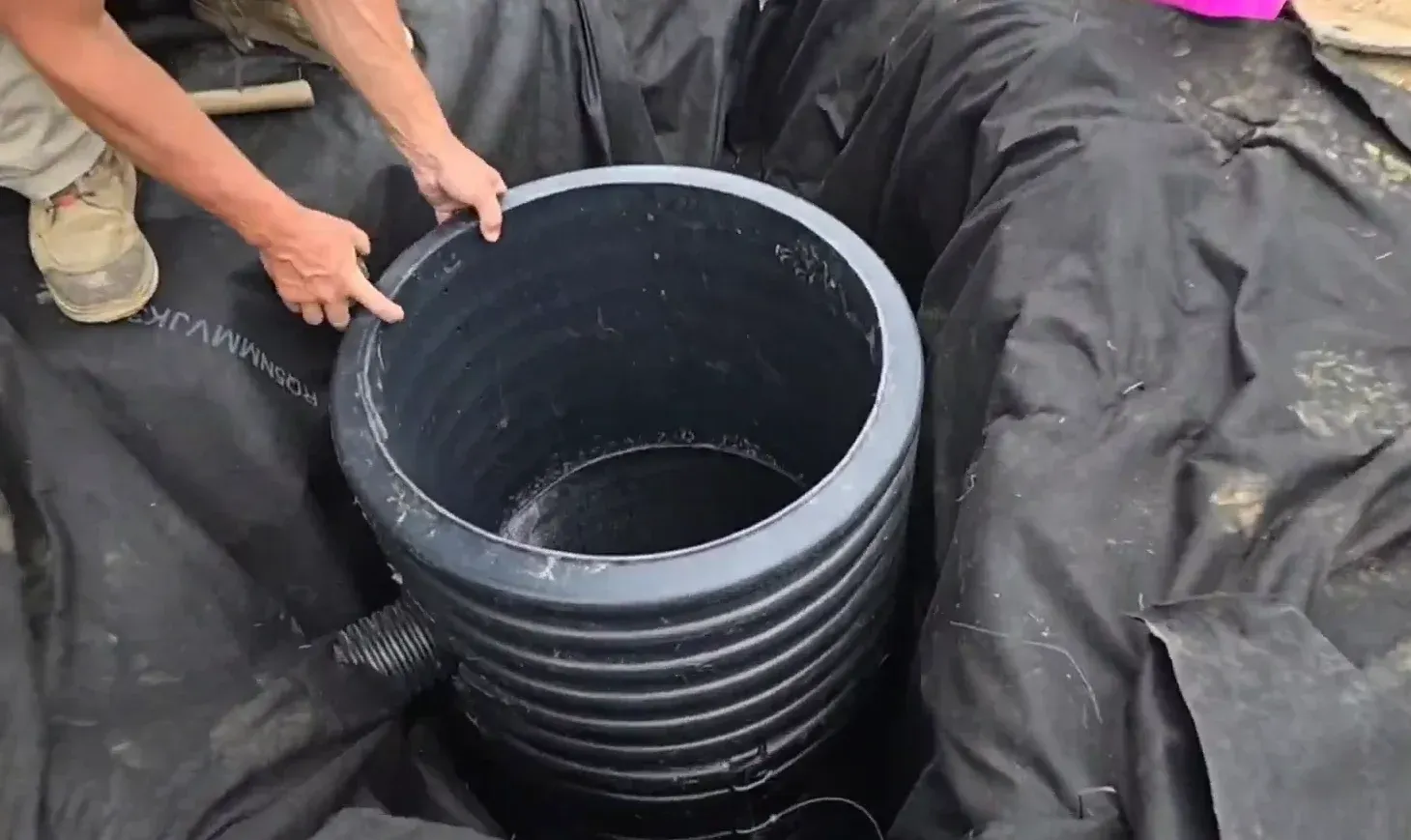 Professional installation of a sump pump dry well basin for basement and foundation protection