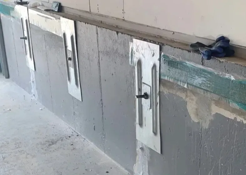 Steel wall plate installed along the interior foundation wall to strengthen and correct structural movement.