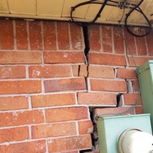 Cracked brick from foundation damage before picture