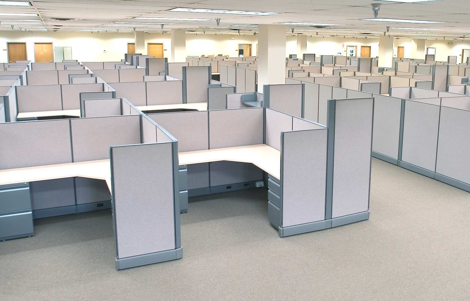 A large empty office with cubicles and desks