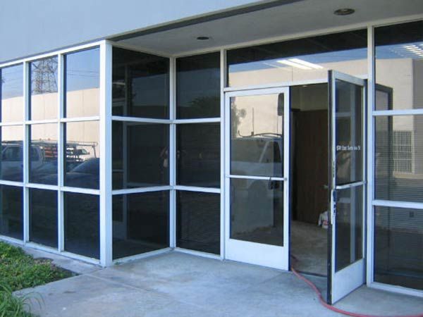 A building with a lot of windows and a door that is open