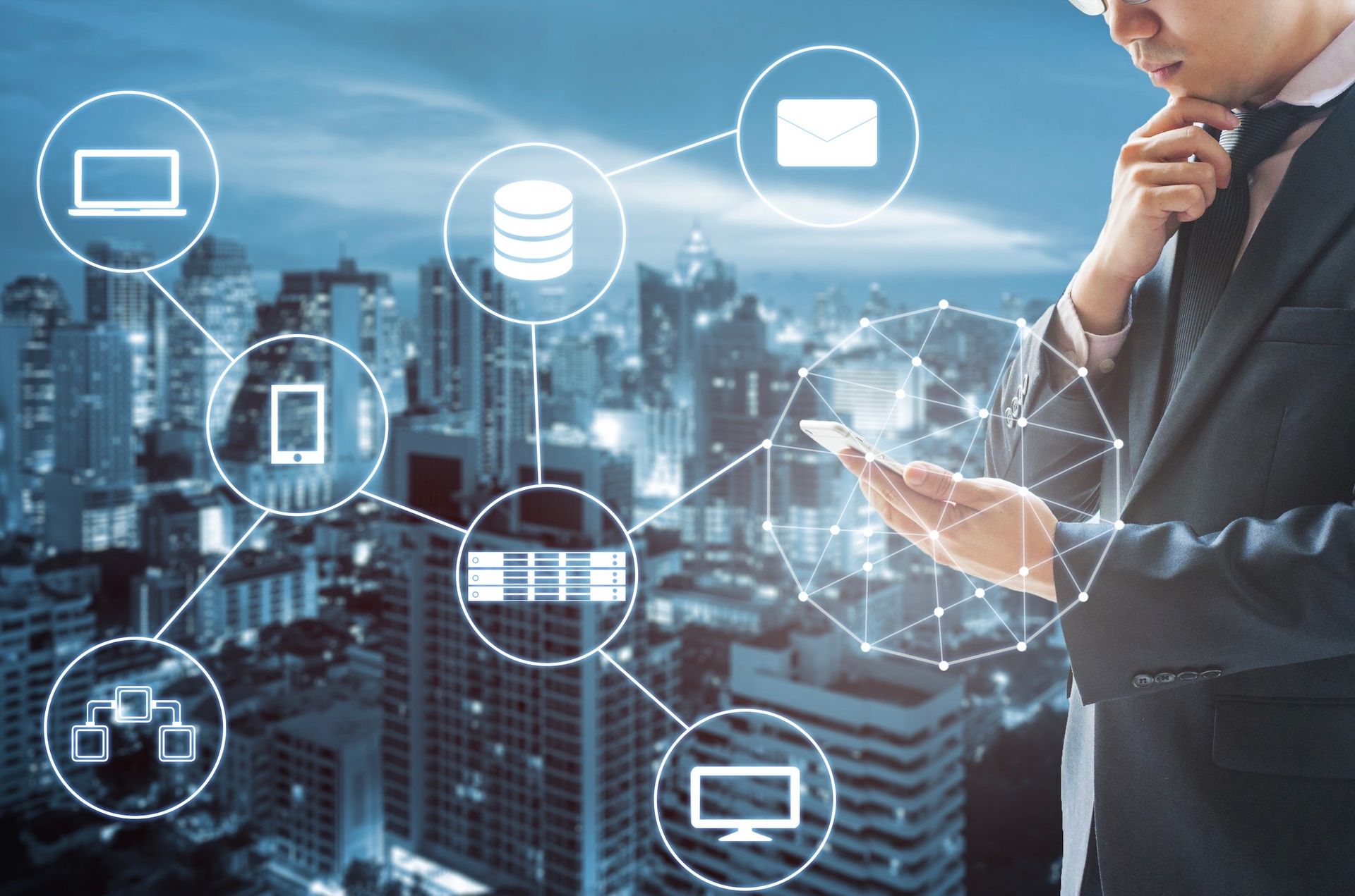 A man in a suit is using a smart phone with a city in the background.