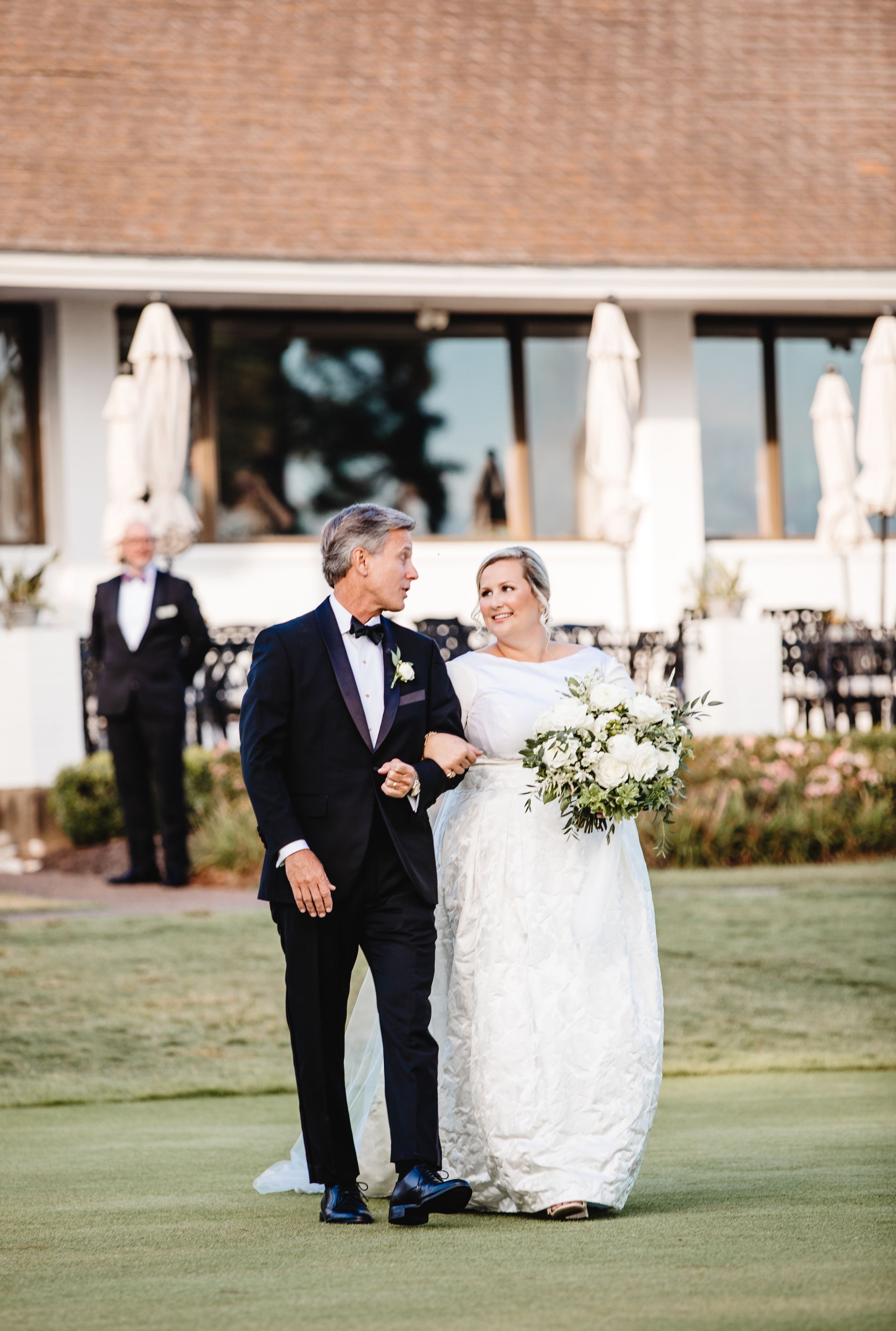 A bride and groom are walking down the aisle at their wedding.