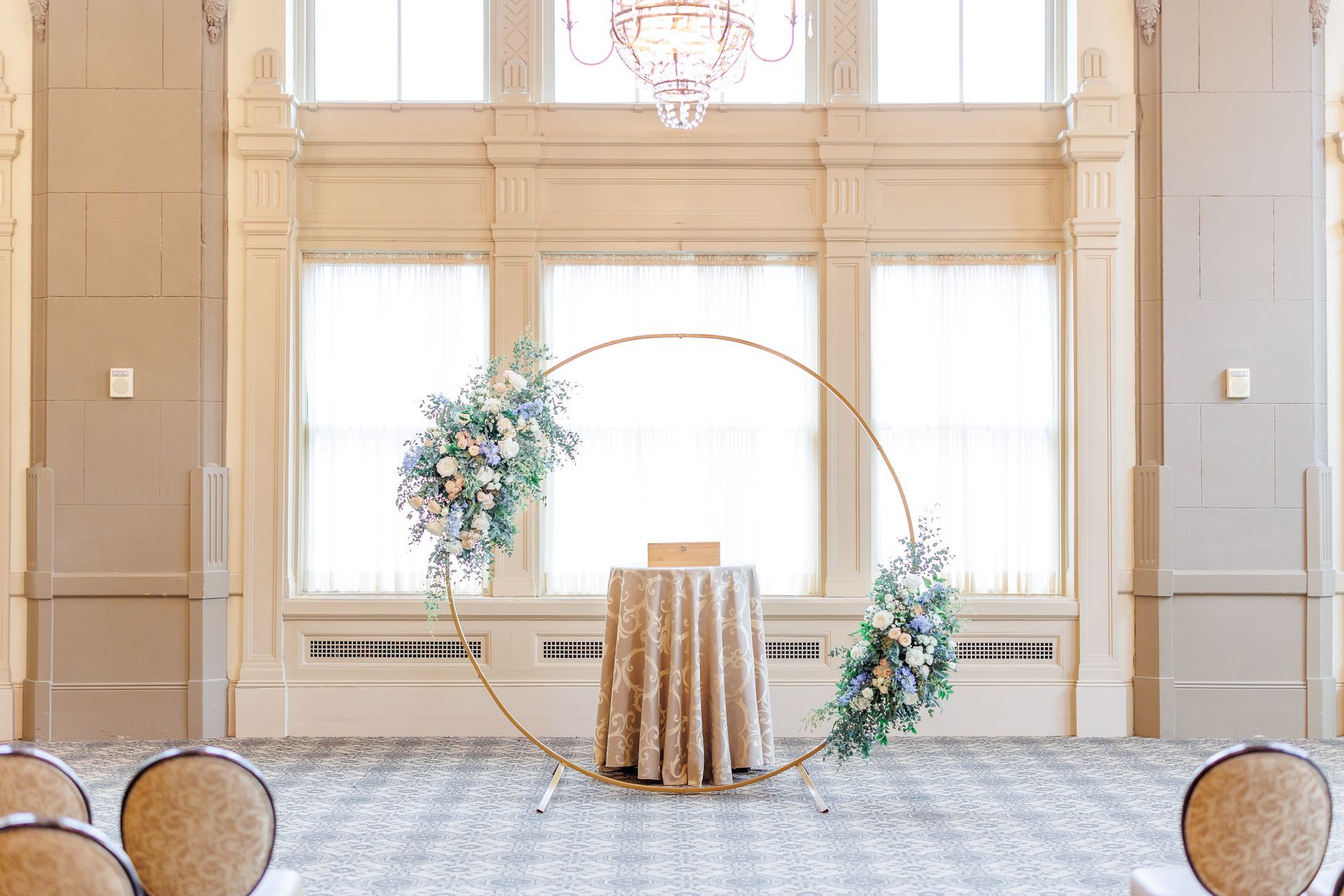There is a table with a table cloth on it in the middle of the room.