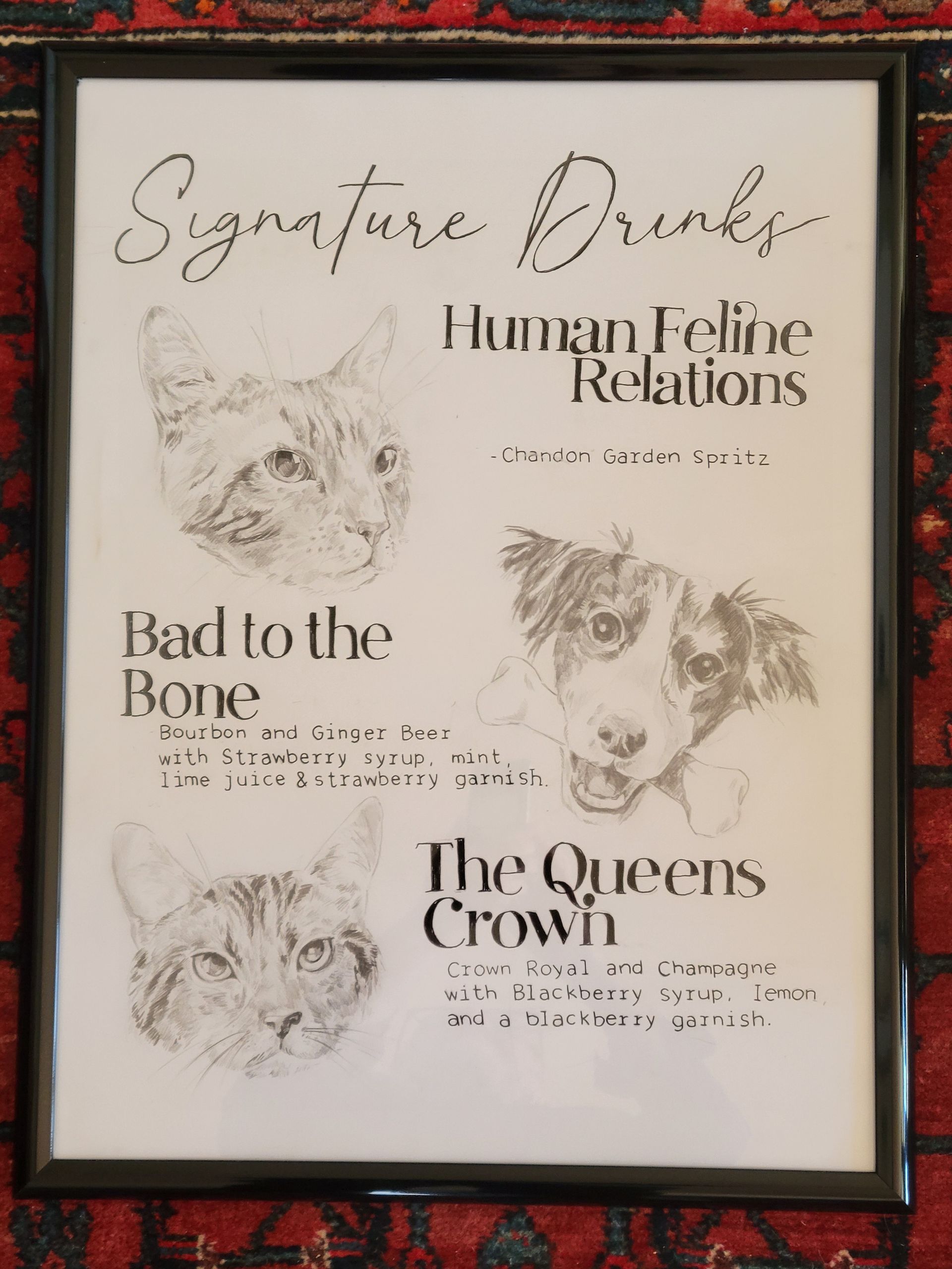 A framed drawing of a cat a dog and the queens crown