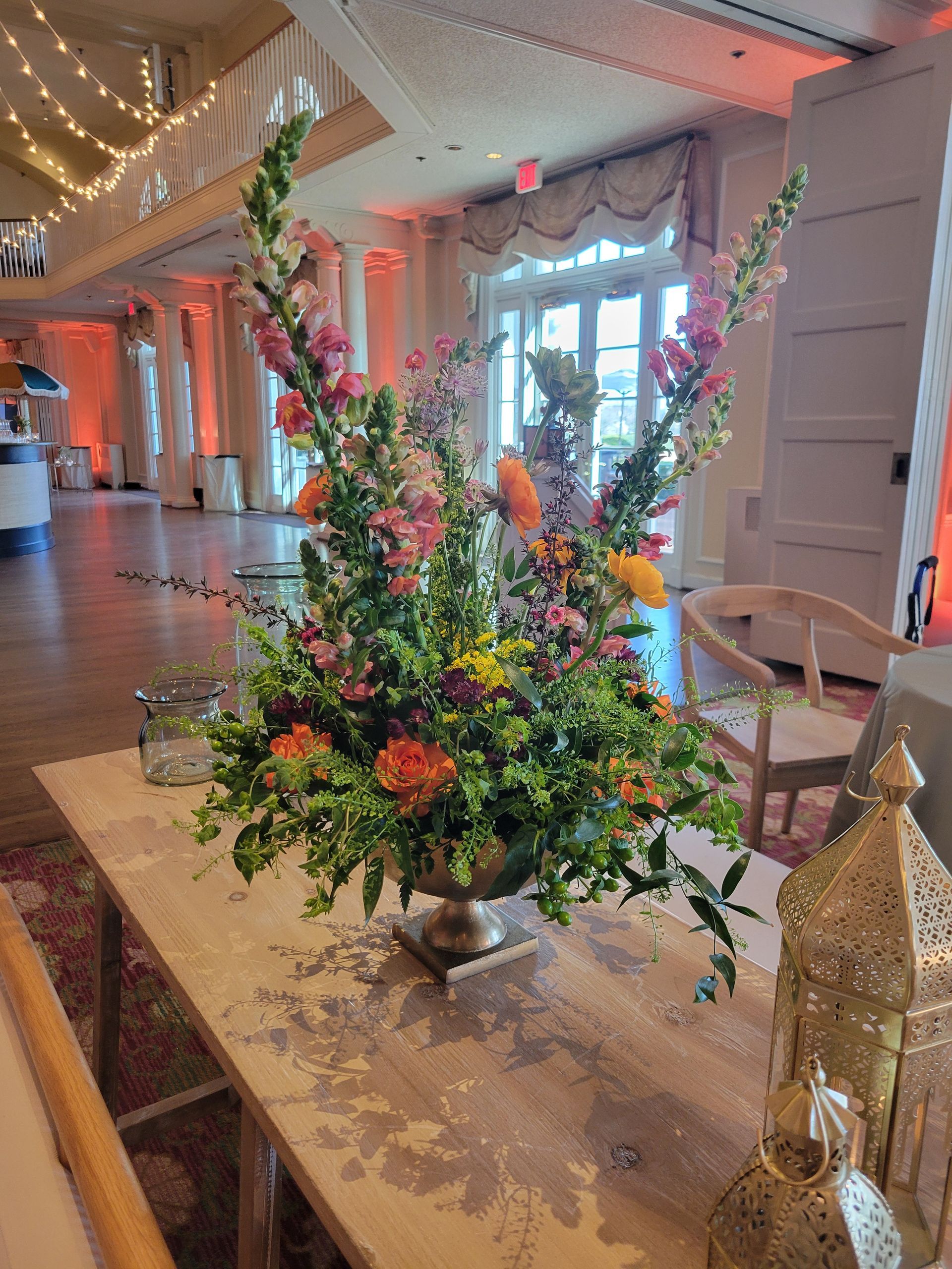 A vase filled with flowers is sitting on a table in a room.