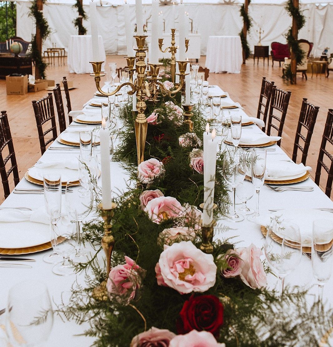 A long table with flowers and candles on it
