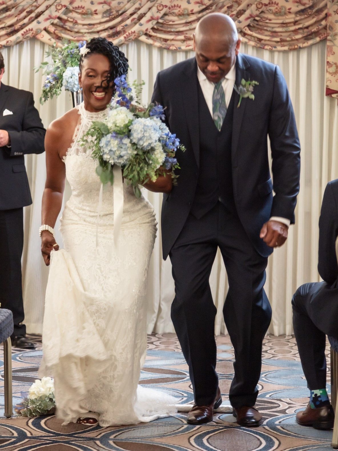 A bride and groom are walking down the aisle at their wedding