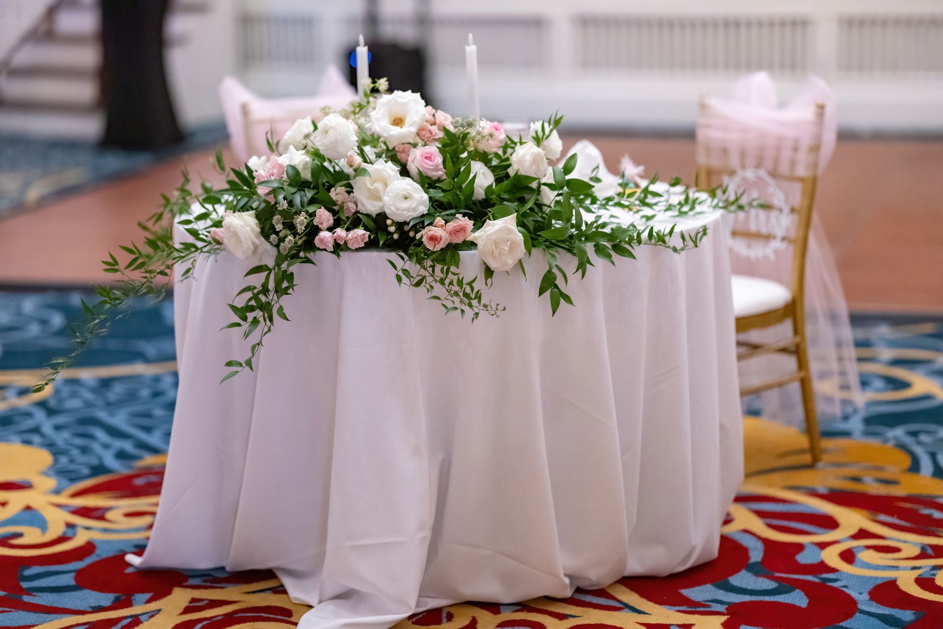 A table with a white tablecloth and flowers on it.