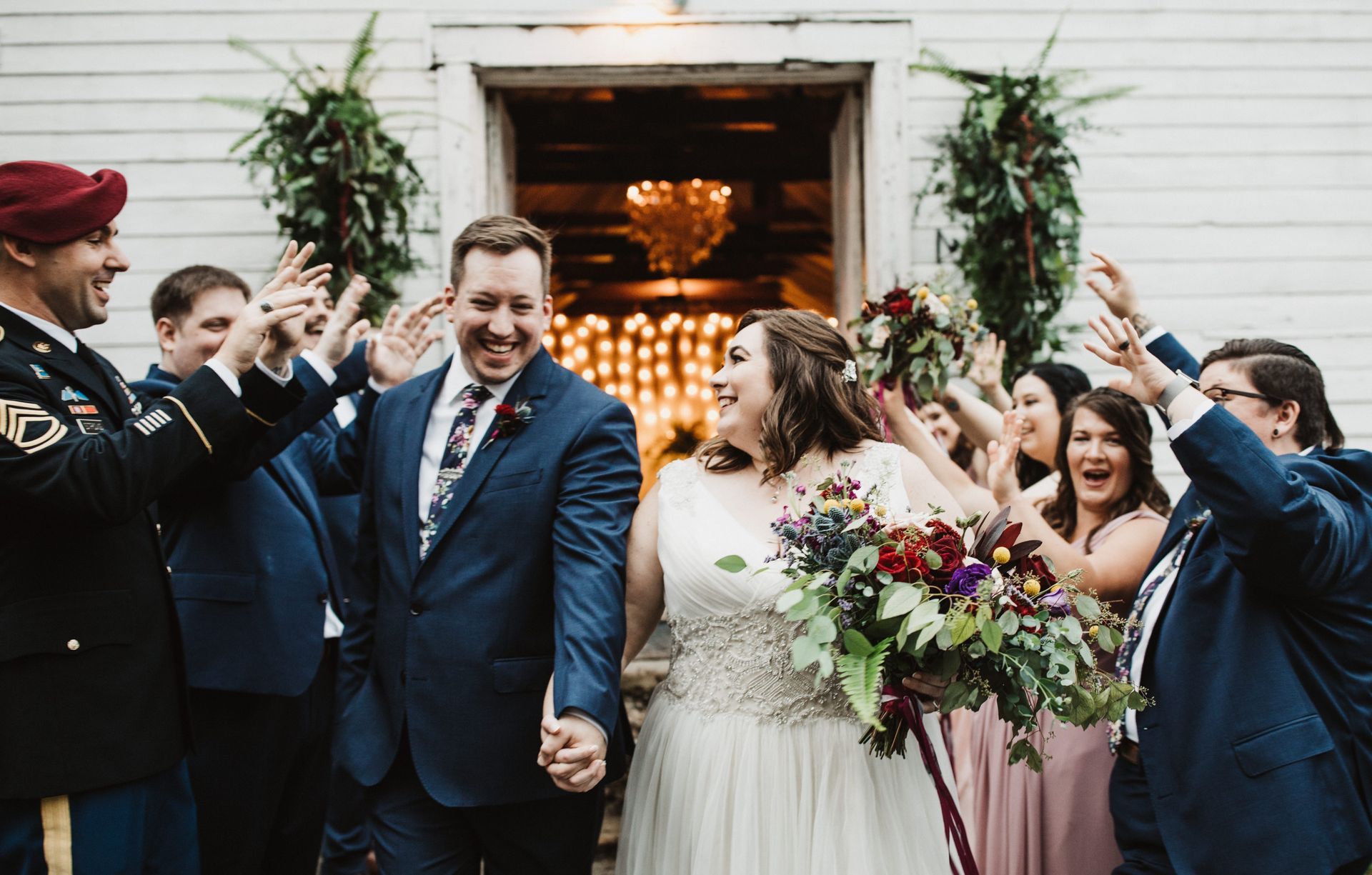 A bride and groom are walking down the aisle with their wedding party.