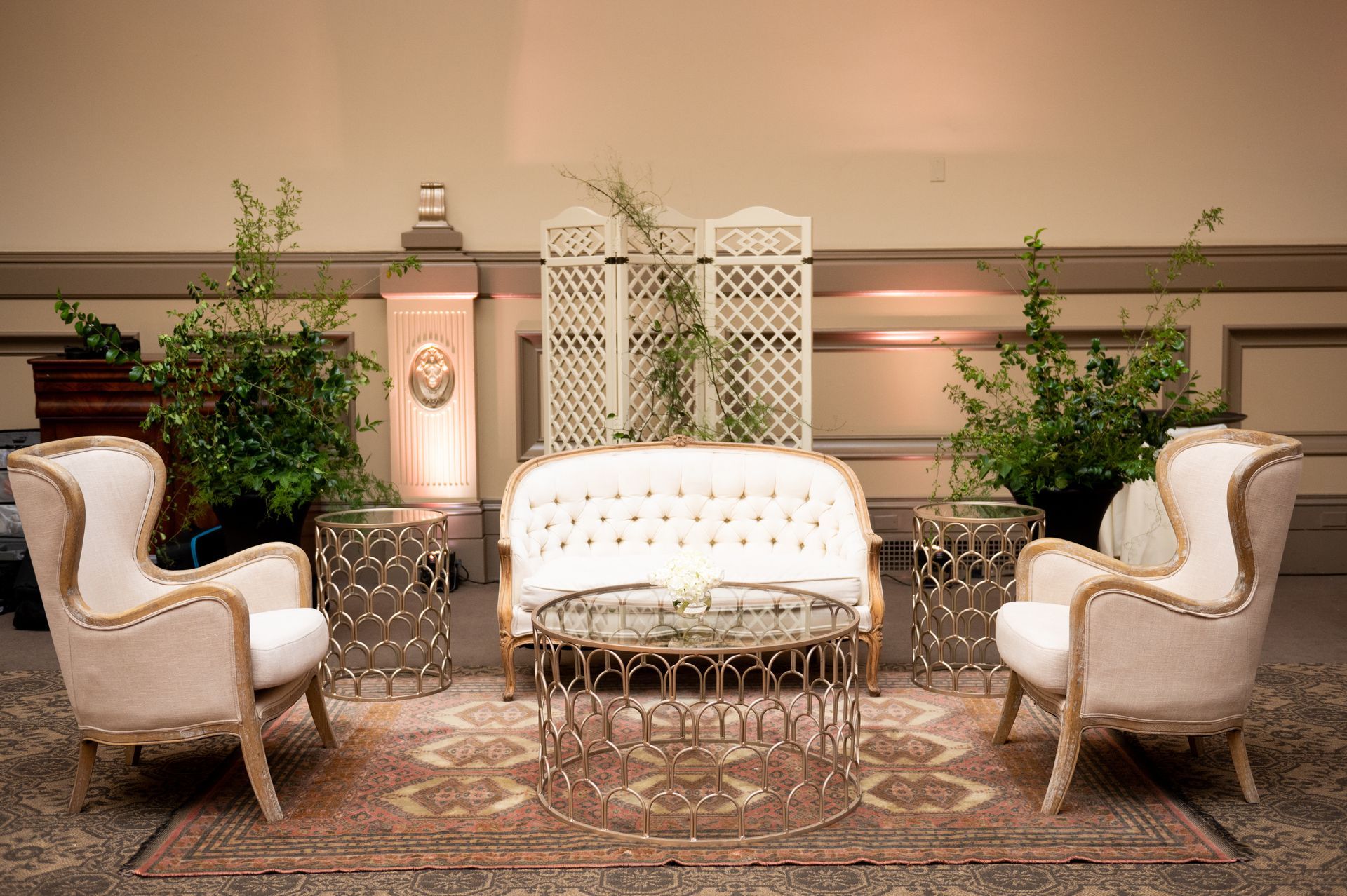 A living room with a couch , chairs , and a table.