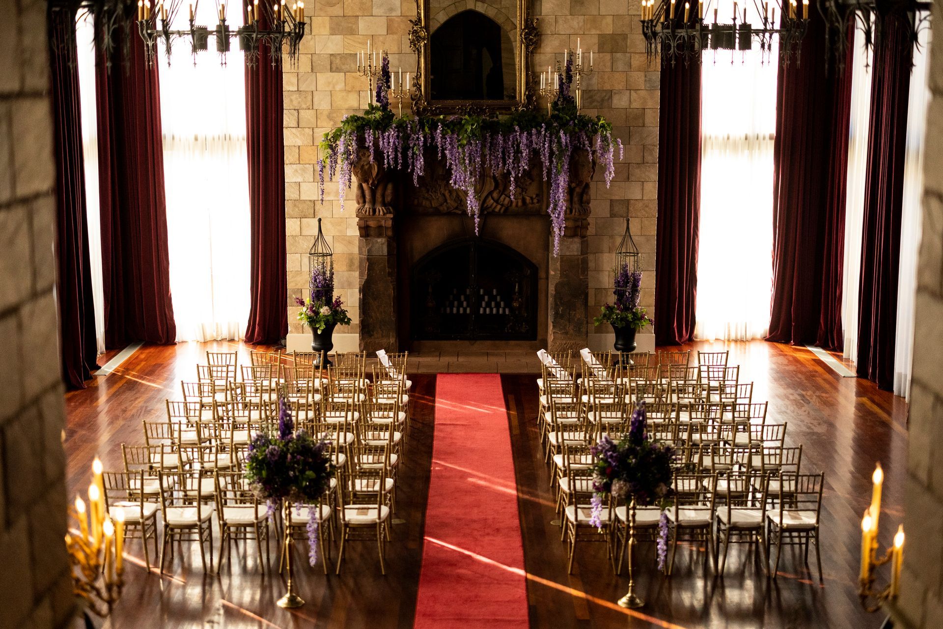 A large room with rows of chairs and a fireplace