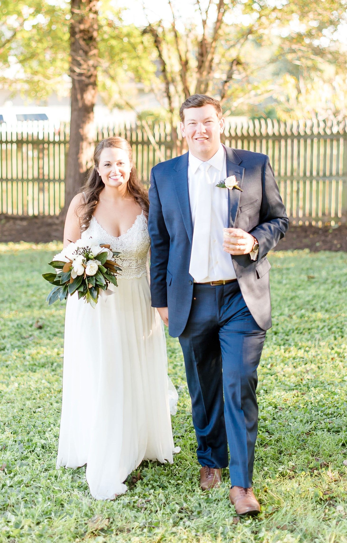A bride and groom are walking down the aisle at their wedding.