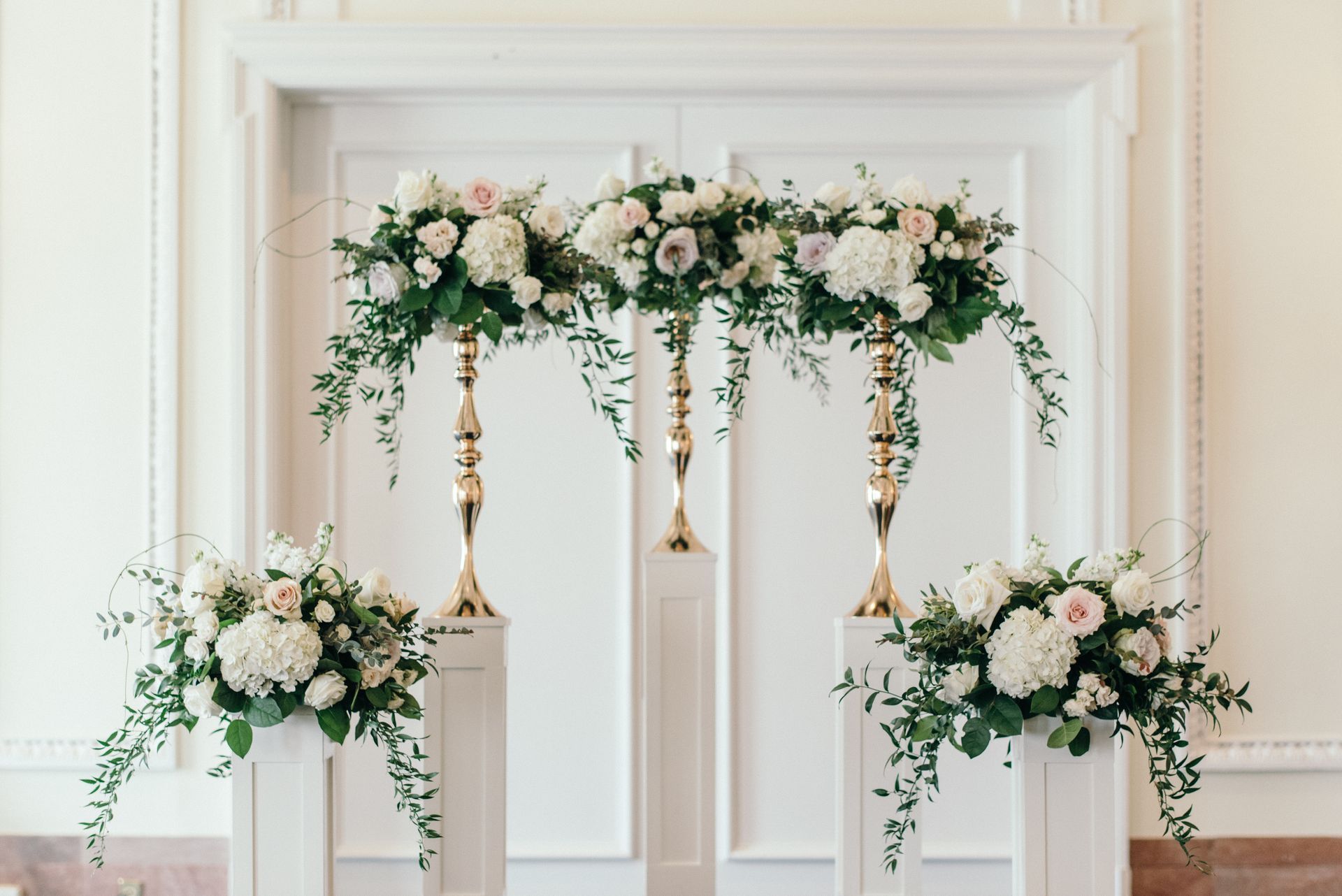 A room decorated with flowers and candles for a wedding ceremony.