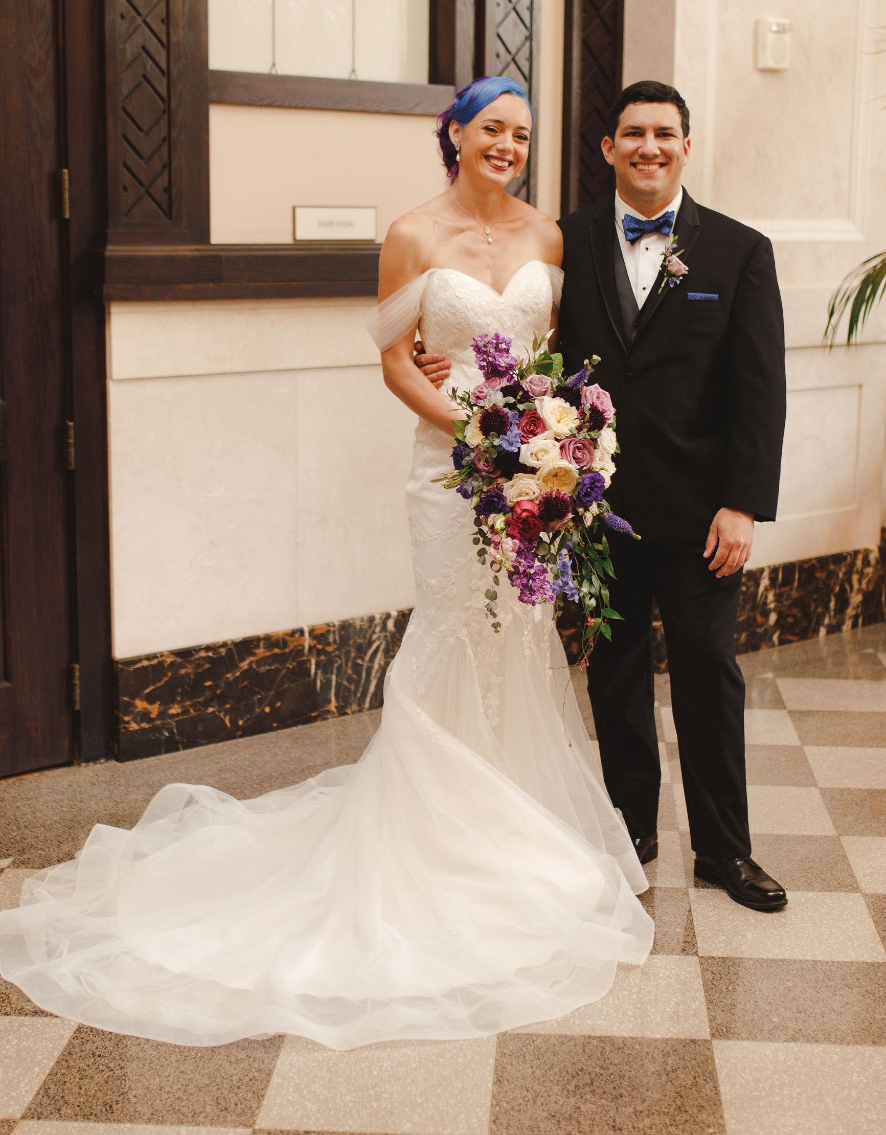 A bride and groom standing next to each other on their wedding day