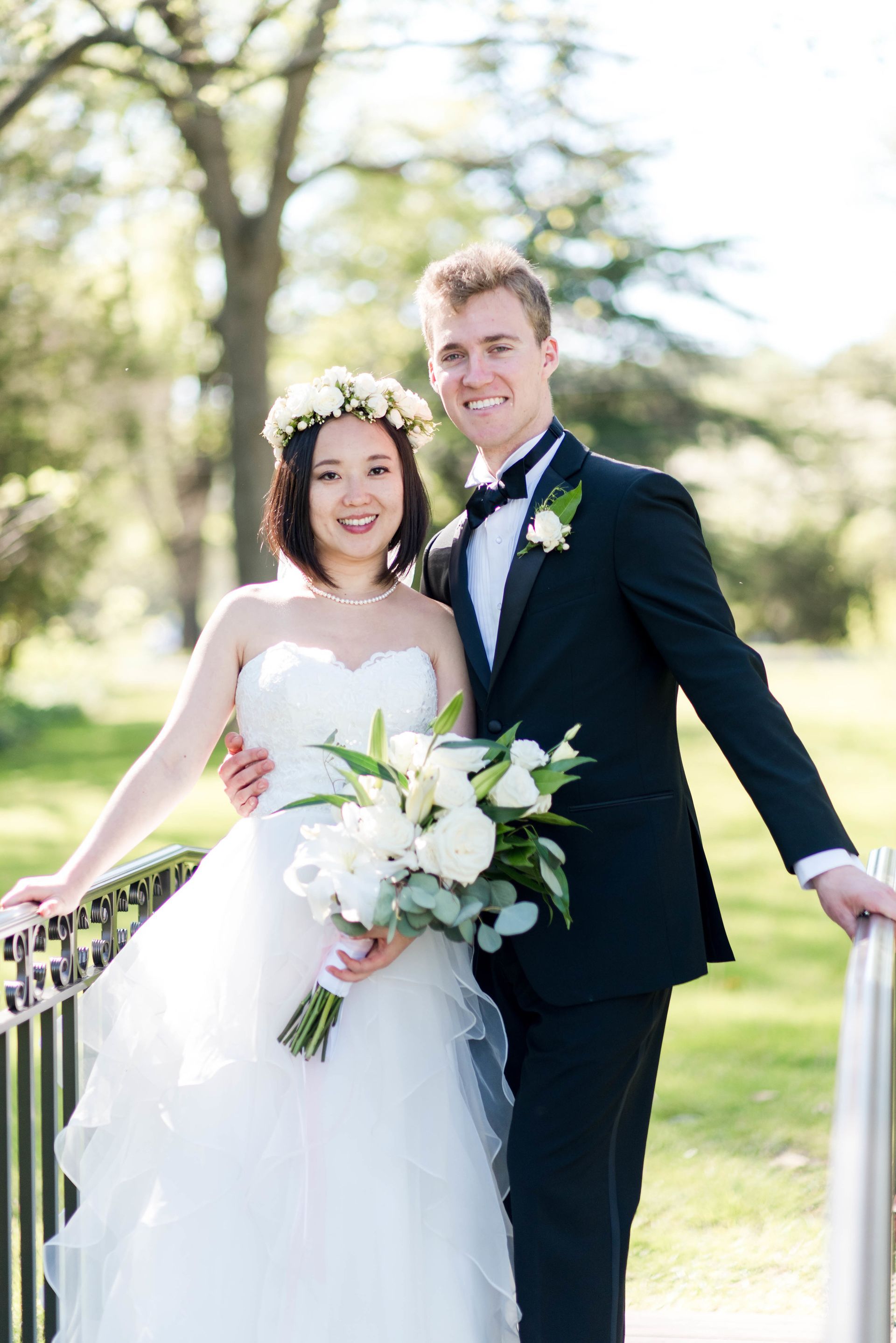 A bride and groom are posing for a picture on their wedding day.