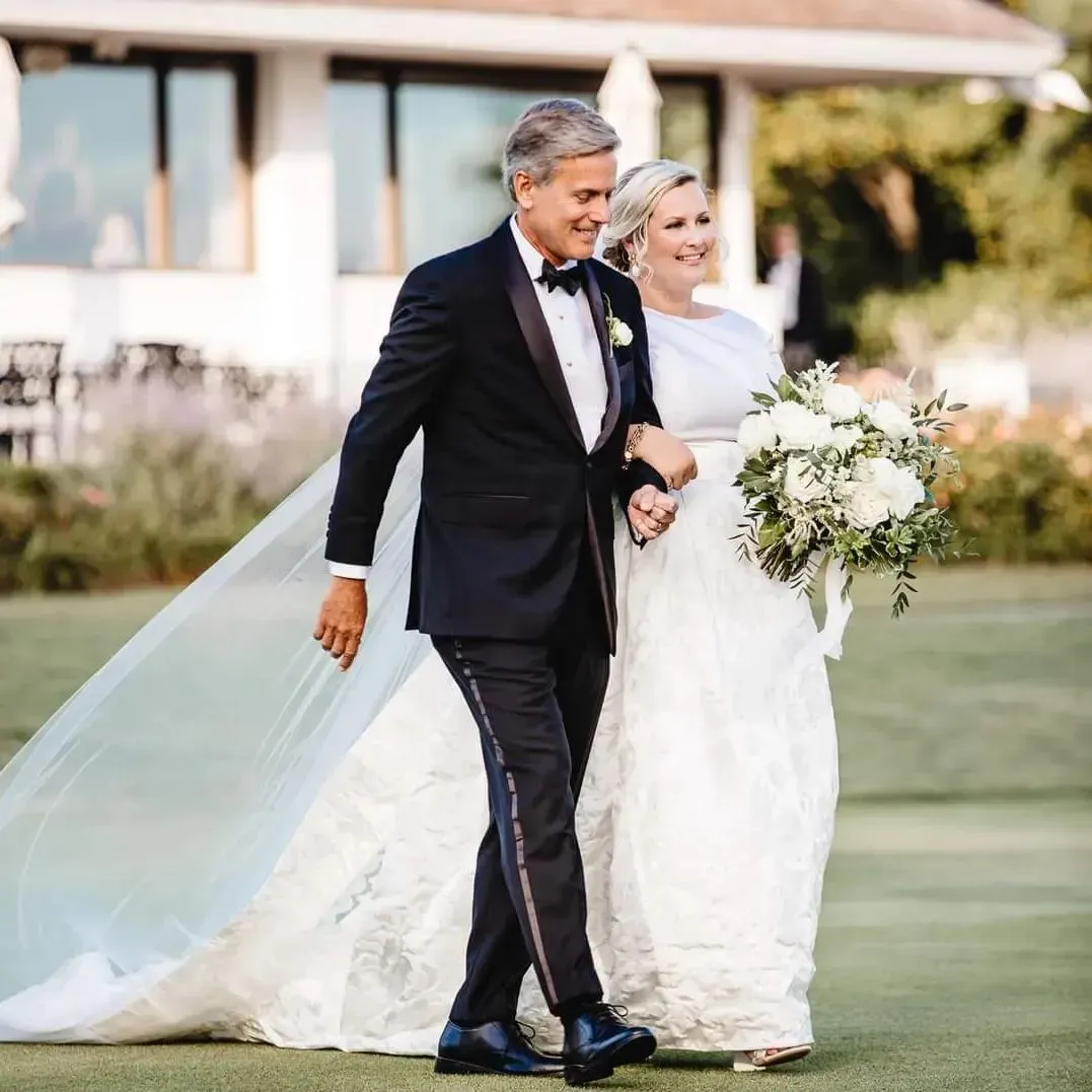 A bride and groom are walking down the aisle at their wedding.