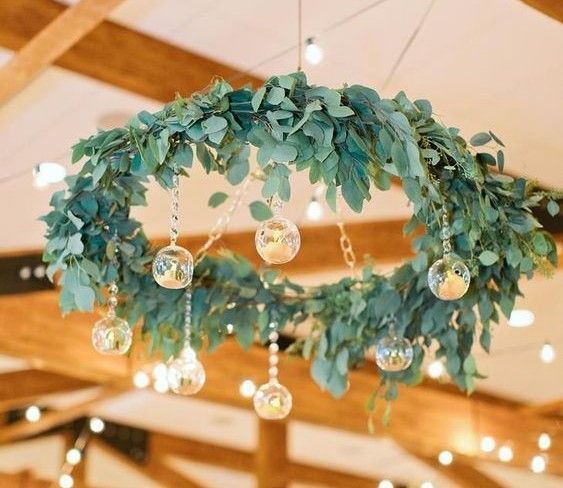 A chandelier made of leaves and glass balls is hanging from the ceiling.