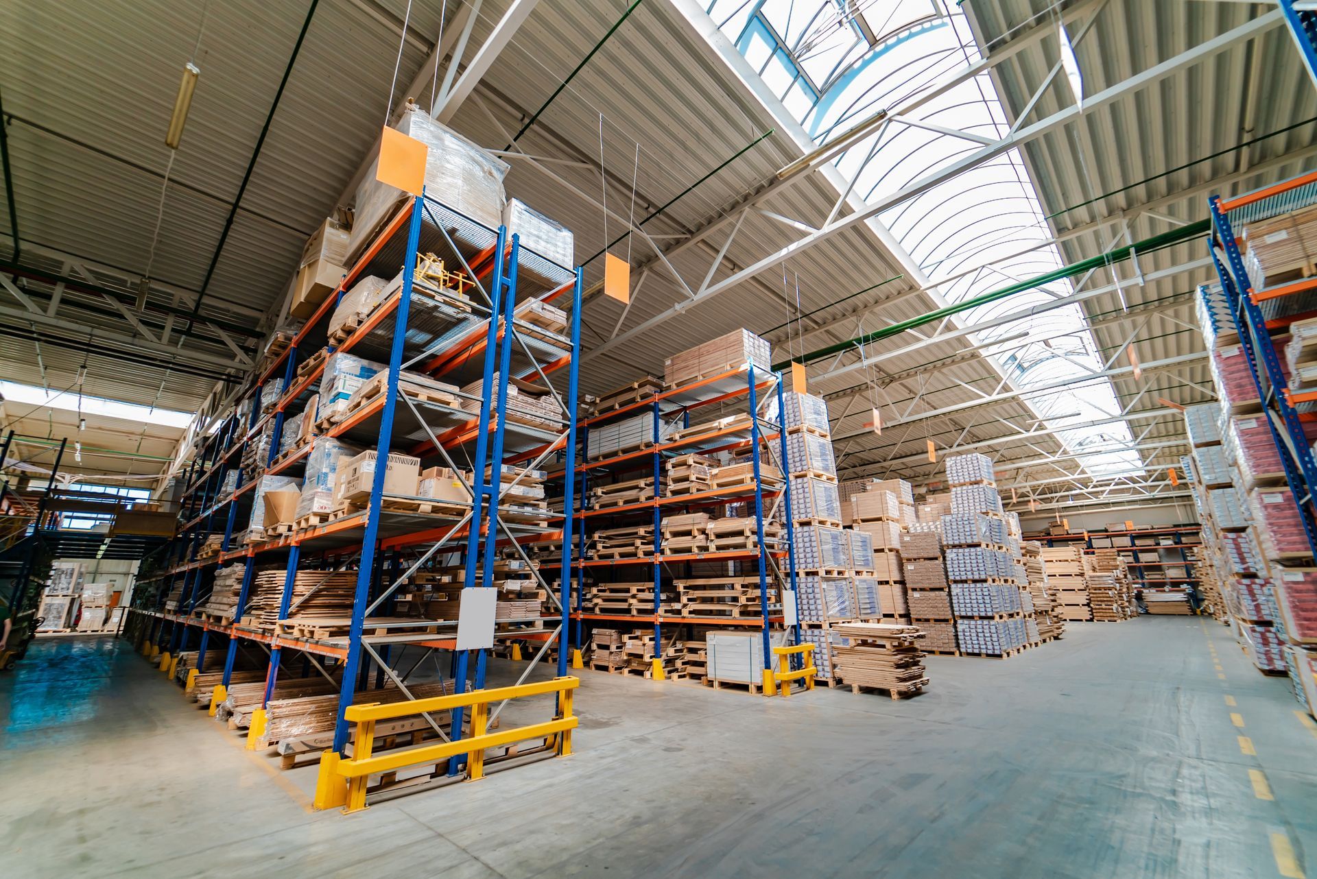 View of a warehouse with many building materials stacked inside.
