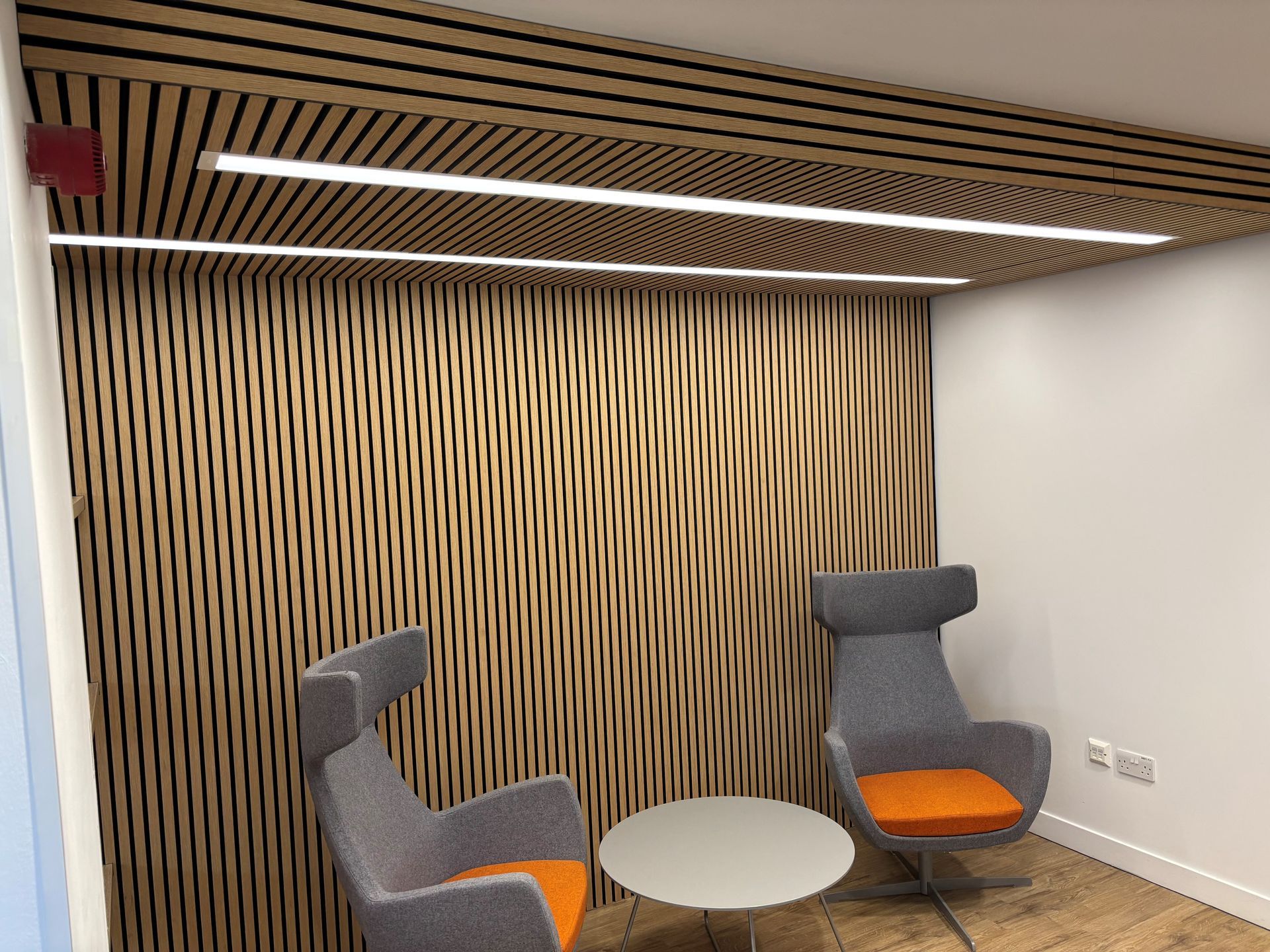 Commercial office fit out with bespoke timber slat wall and contemporary seating