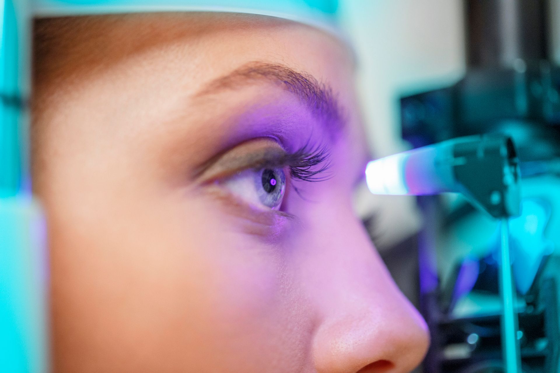 A close up of a woman 's eye being examined by an ophthalmologist.