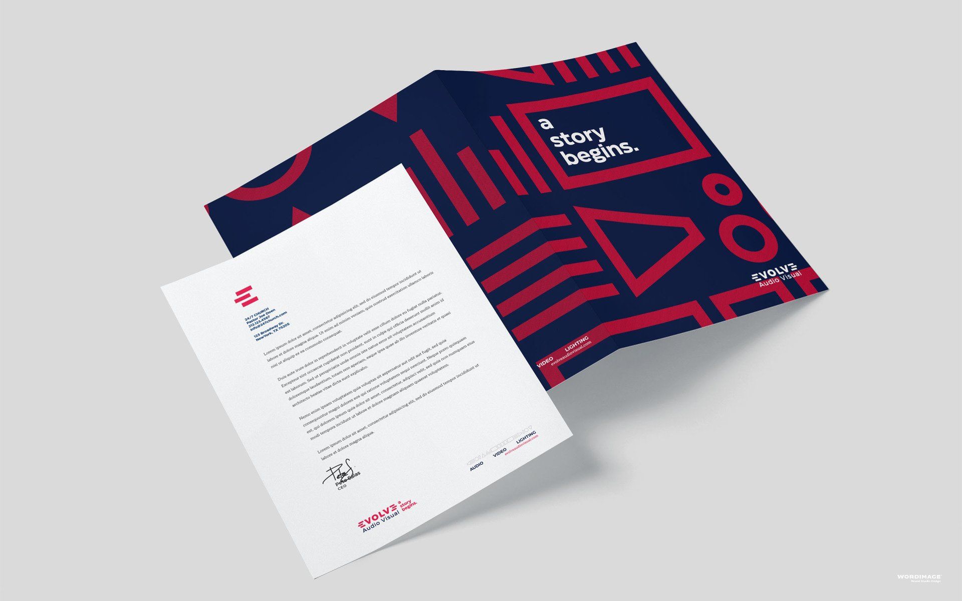 A mockup of a letterhead and a brochure on a table.