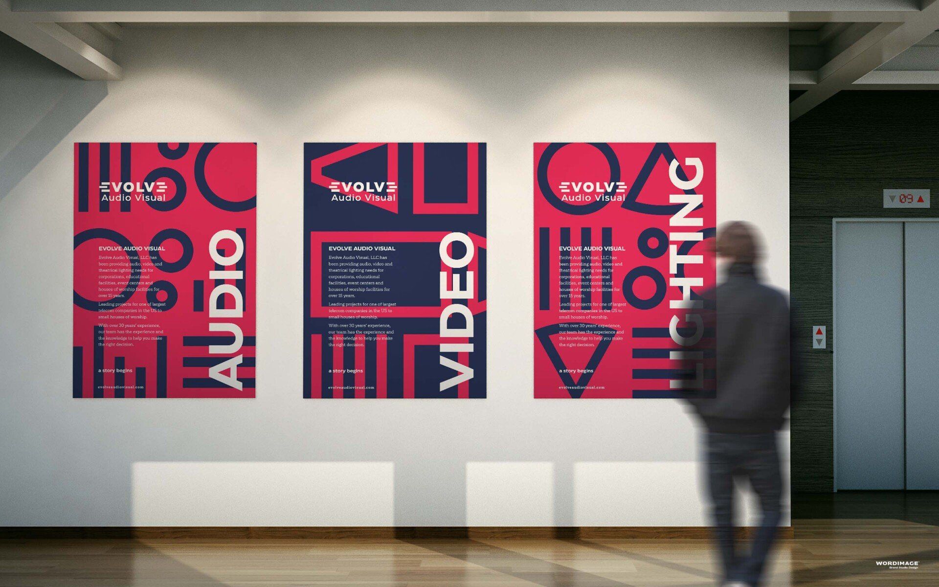 A man is standing in front of three posters on a wall that say audio video and lighting