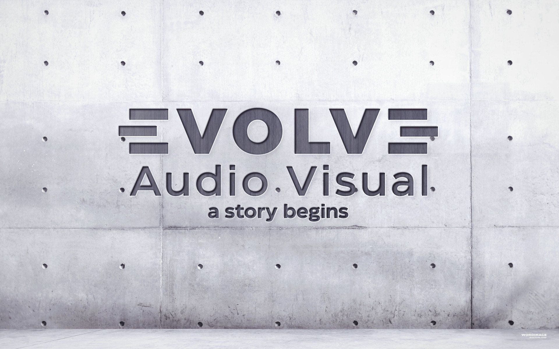 A concrete wall with the words evolve audio visual written on it