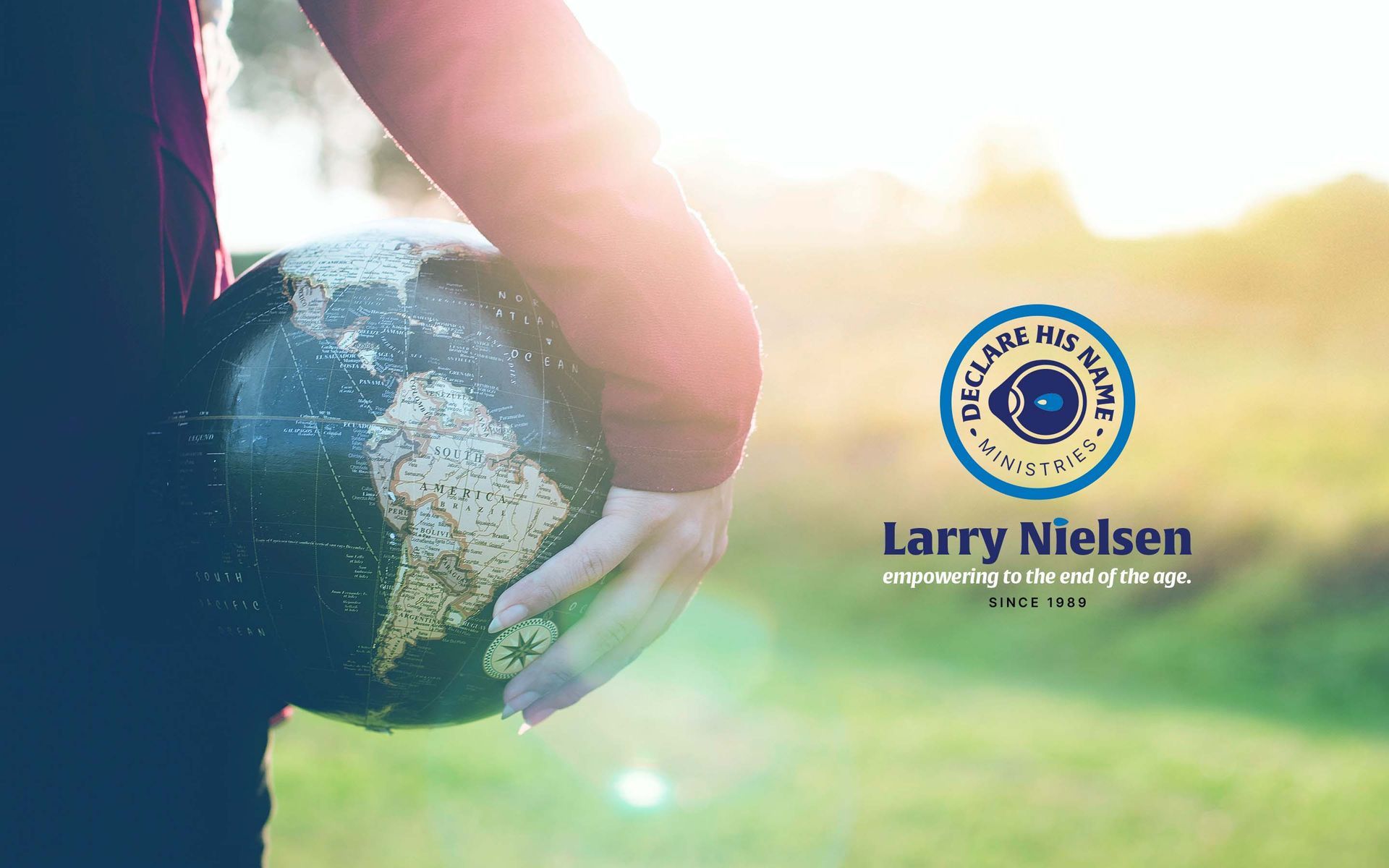 A person is holding a globe in their hand.