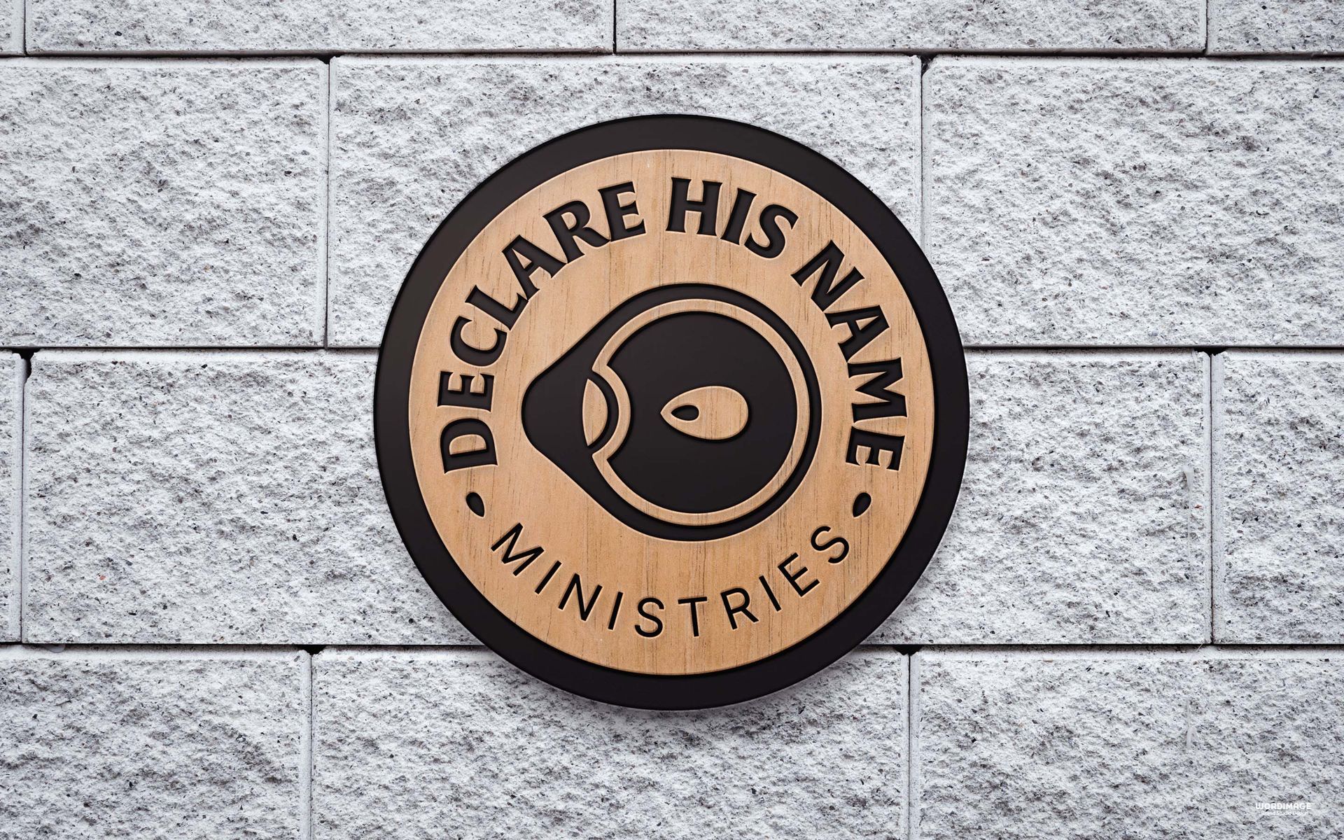 A sign on a brick wall that says declare his name ministries