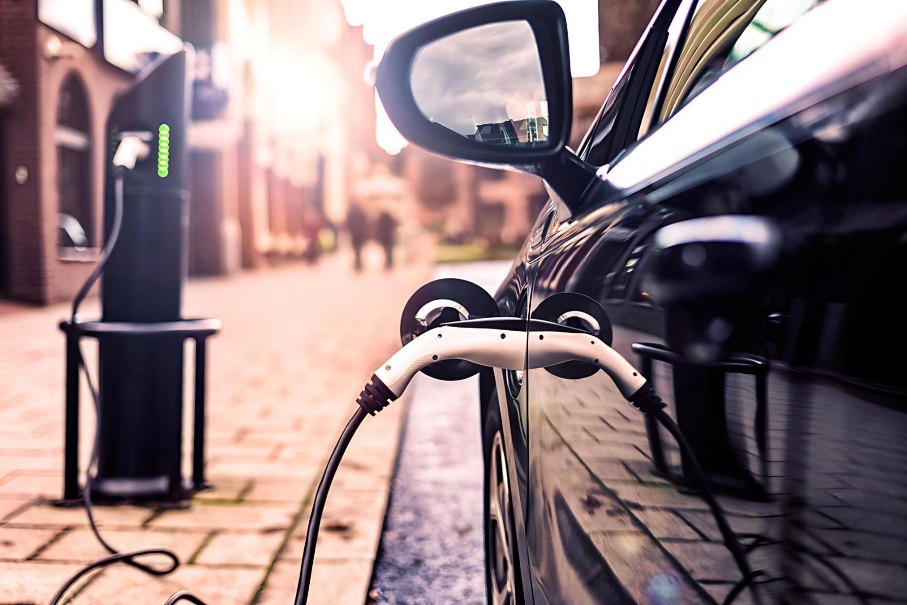 Electric vehicle at a public charging station, compared with home EV charger installation