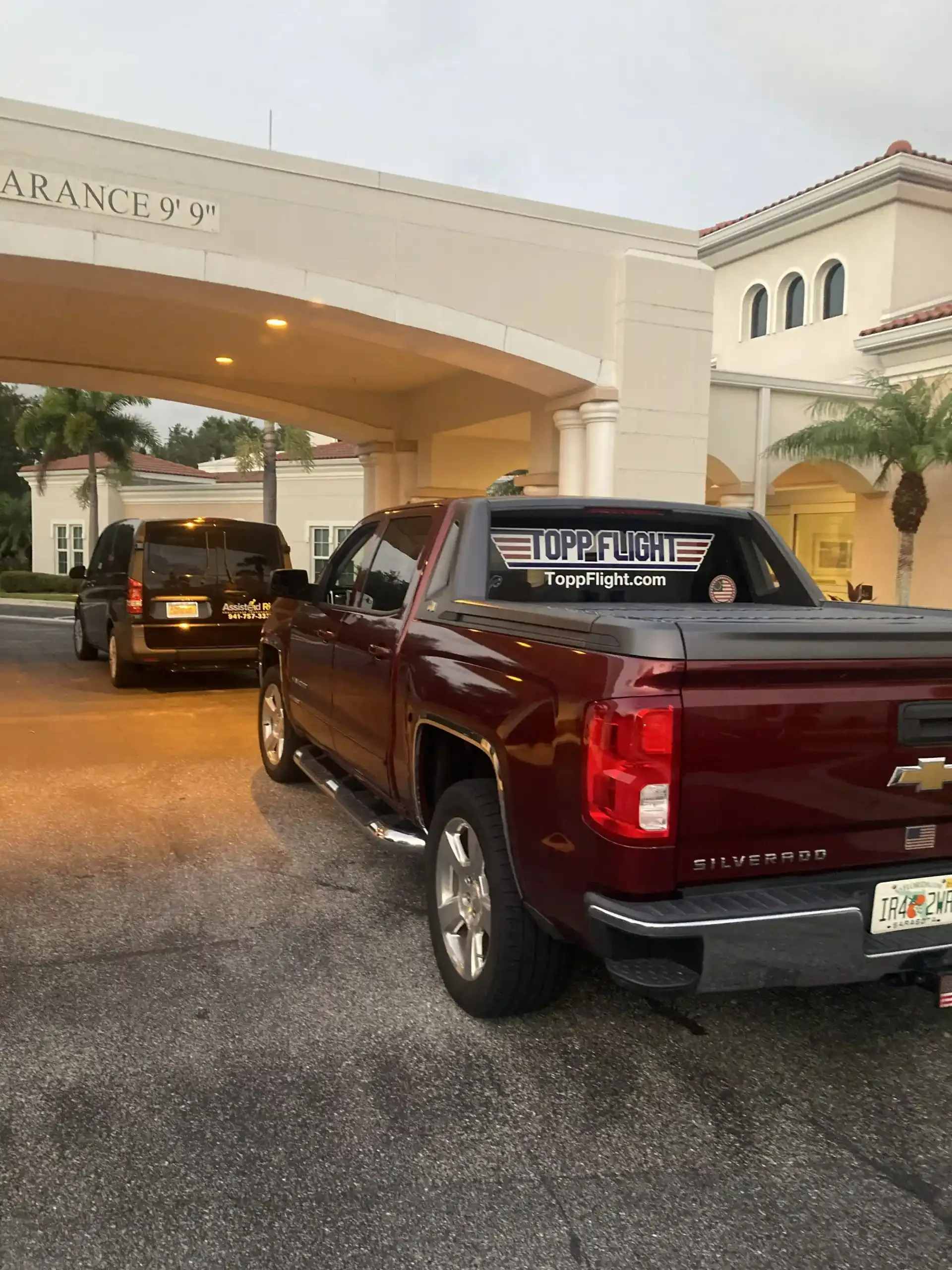 A red truck is parked in front of a building.