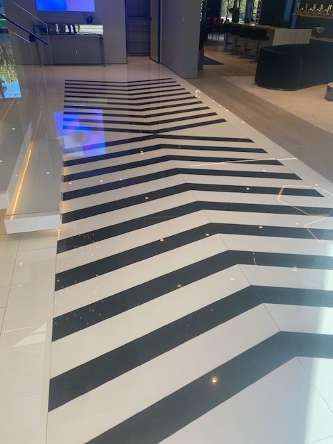 Black-and-white striped floor design in a modern indoor lobby or mall corridor