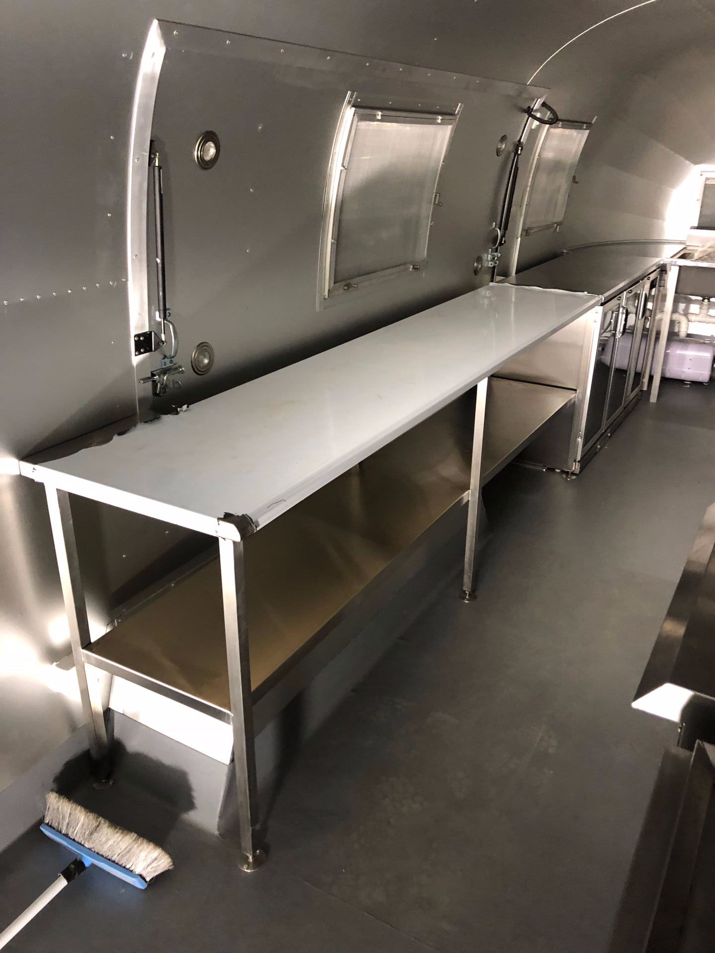 A Kitchen in an Airstream With Stainless Steel Tables and a Broom — EB Metalworks in Somersby, NSW
