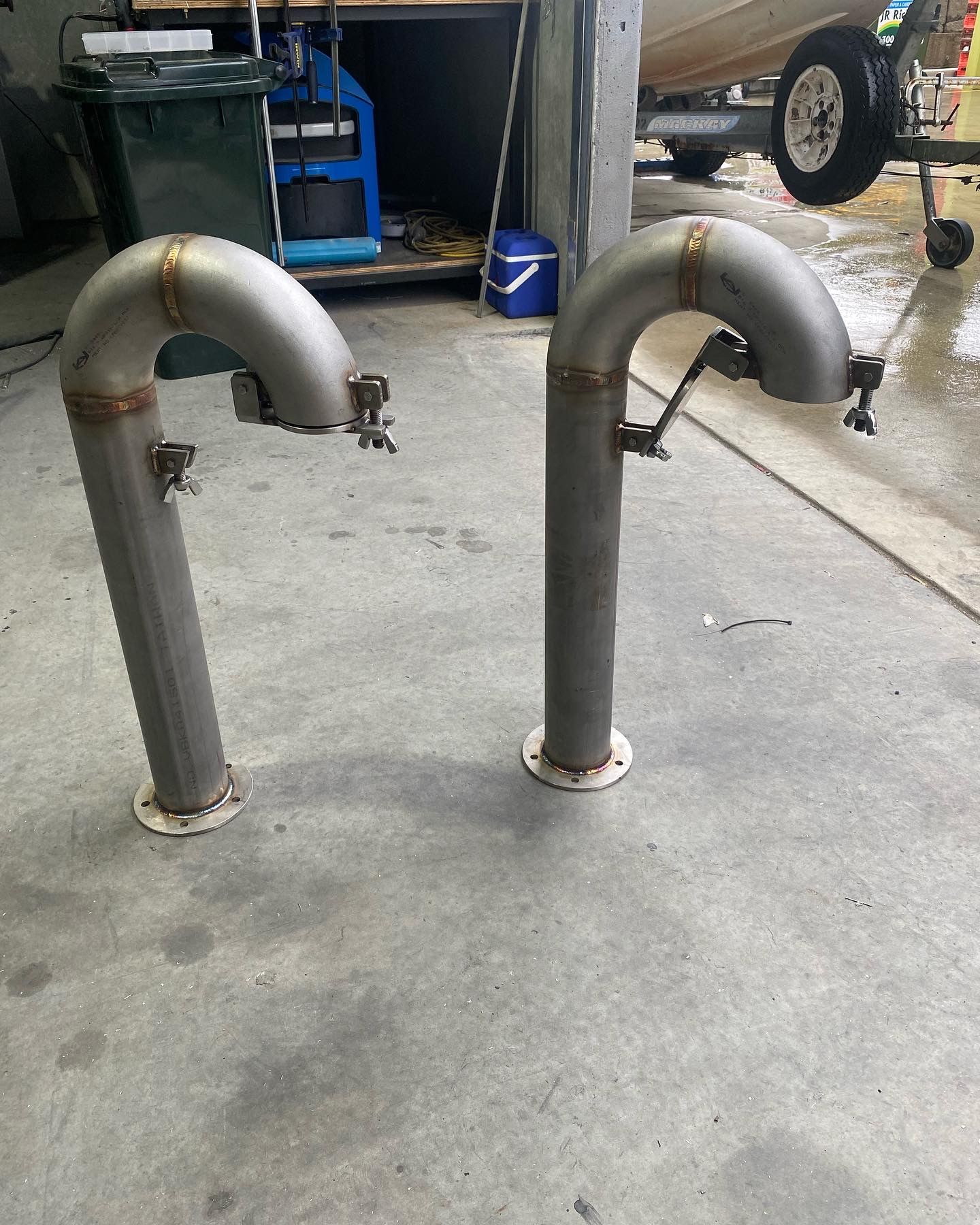 Two Stainless Steel Pipes With Faucets on Them Are Sitting on a Concrete Floor — EB Metalworks in Somersby, NSW