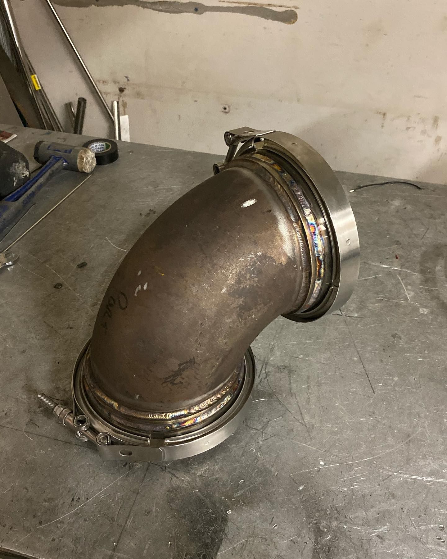 Welded Metal Elbow Pipe Fitting on A Workbench in A Workshop — EB Metalworks in Erina, NSW