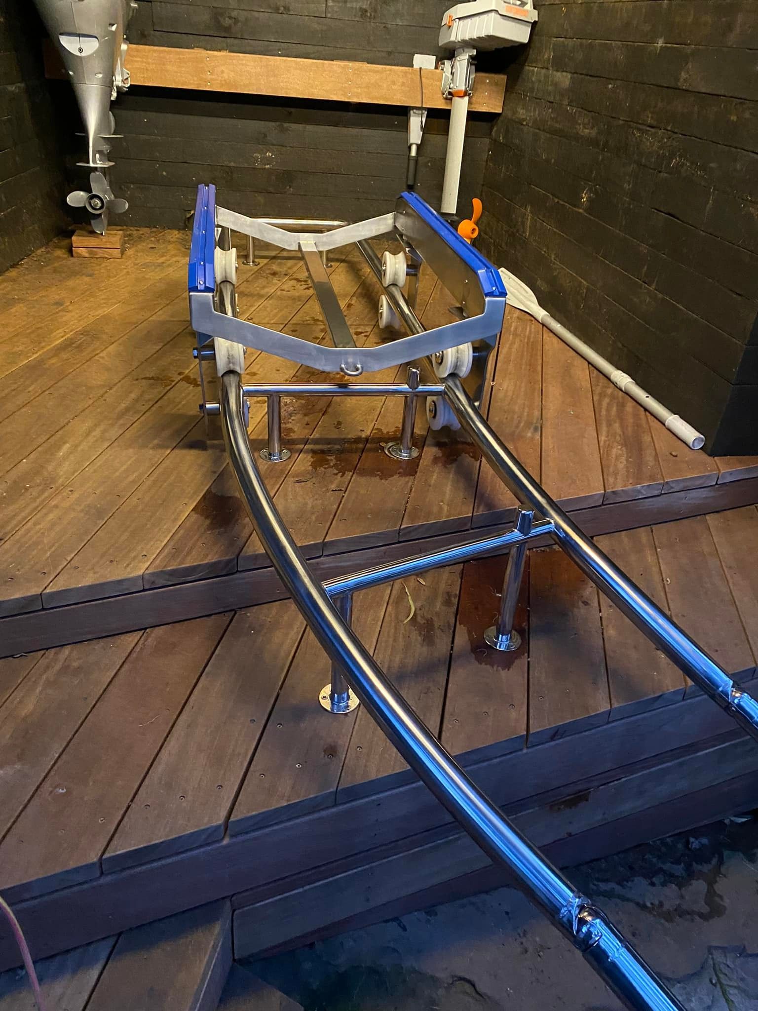 Blue Metal Frame on Wooden Floor Inside a Narrow Boat or Cabin Interior, with Exposed Pipes and Beams — EB Metalworks in Woy Woy, NSW