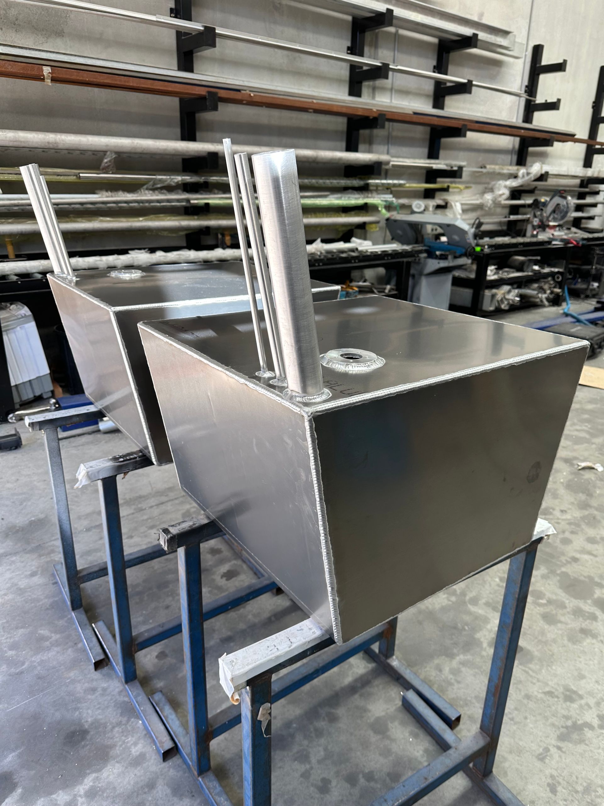 Two Stainless Steel Tanks Are Sitting on a Table in a Factory — EB Metalworks in Kincumber, NSW
