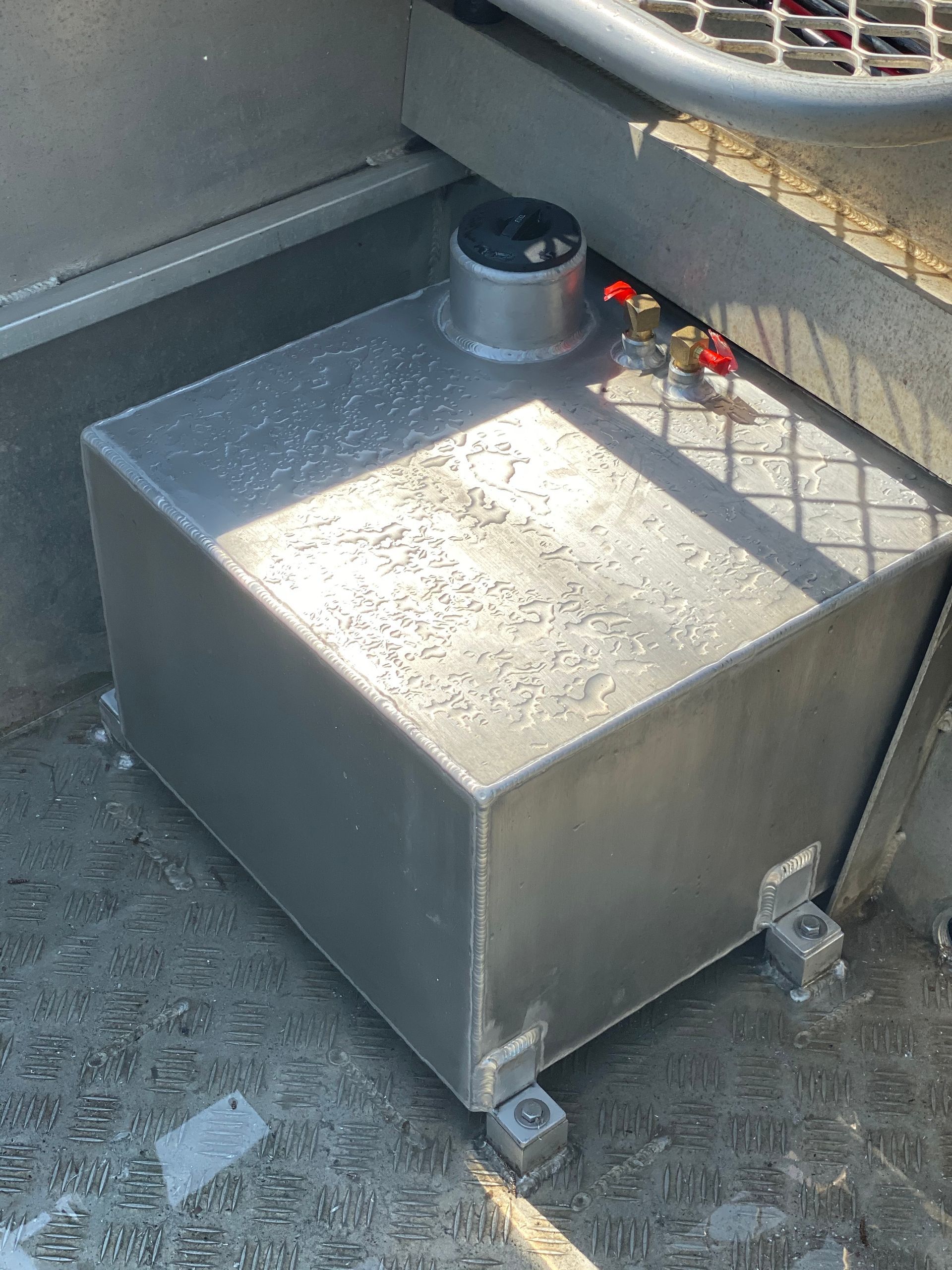 Metal Utility Tank with A Black Cap on A Concrete Surface, Beside a Railing and Small Red Valve Handles — EB Metalworks in Terrigal, NSW