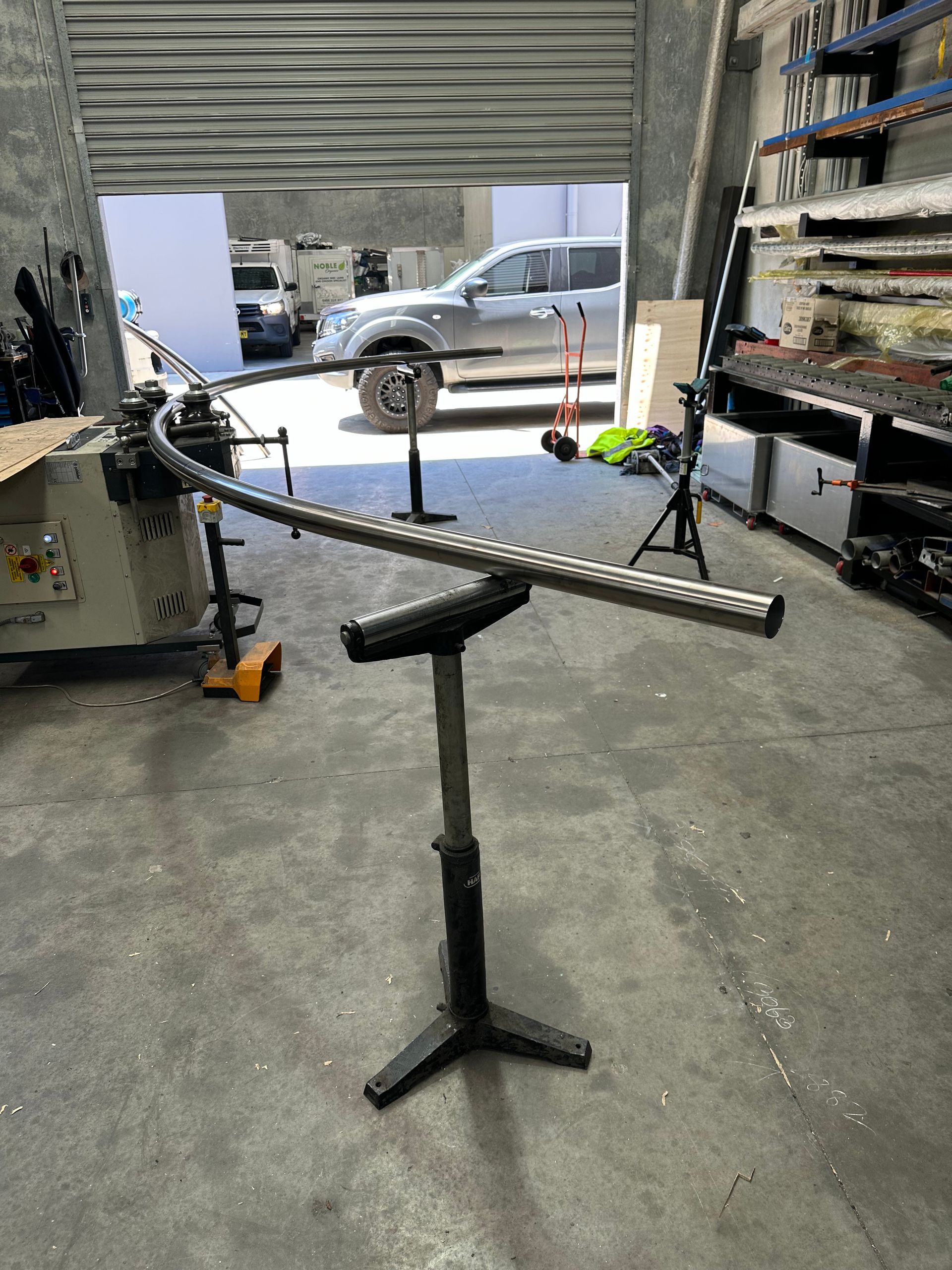 Shop Stand Holding a Bent Metal Frame in A Garage or Workshop — EB Metalworks in Berkeley Vale, NSW
