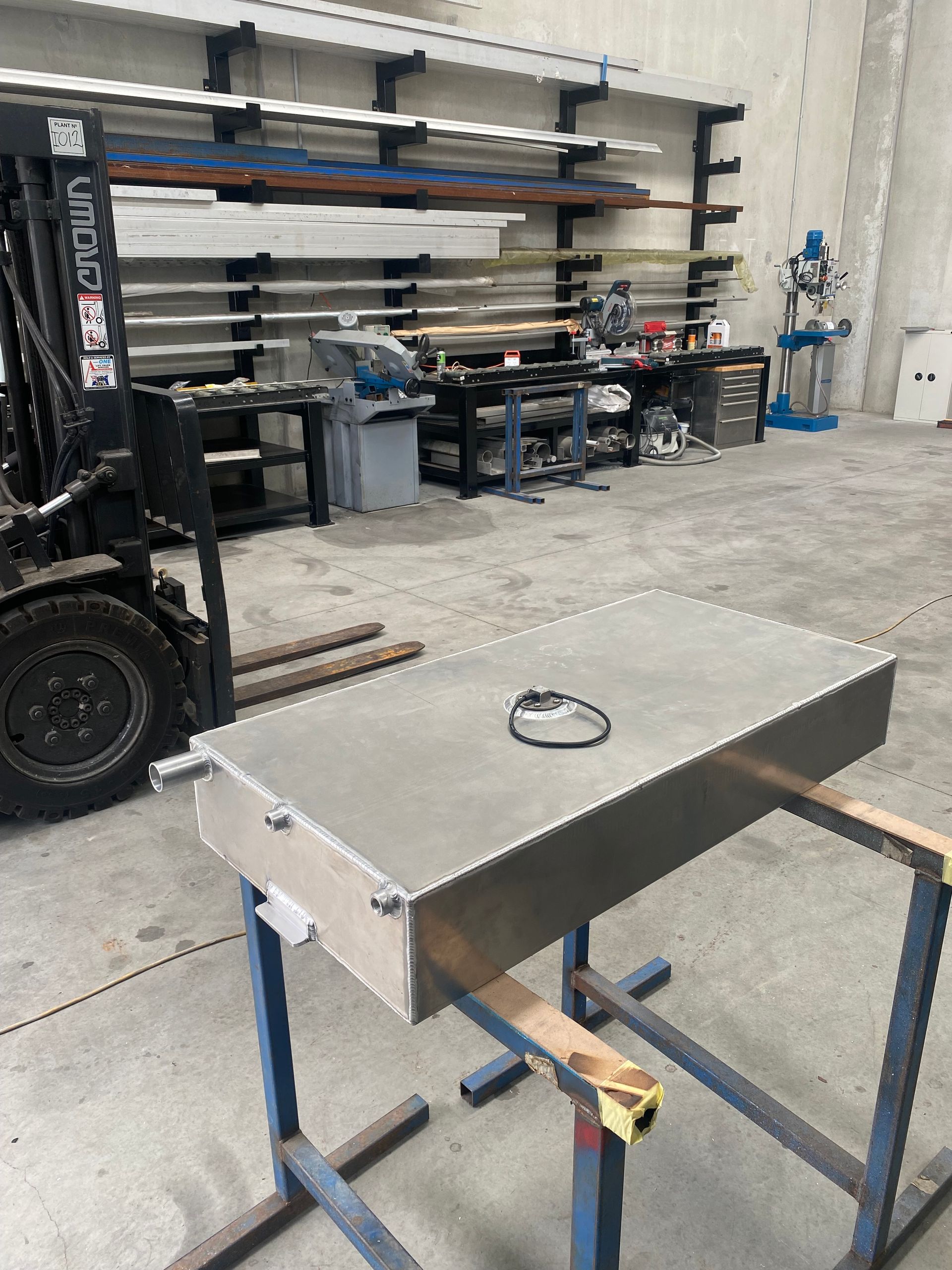 Metal Workbench in A Garage with A Small Ring on Top and Shelves of Tools in The Background — EB Metalworks in Woy Woy, NSW