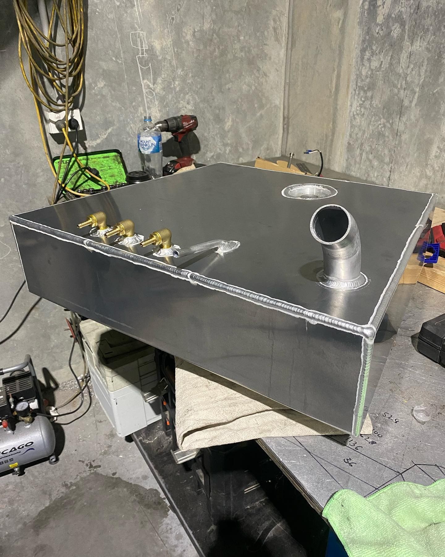 Metal Tank with Fittings and A Pipe on A Workbench in A Workshop — EB Metalworks in Somersby, NSW