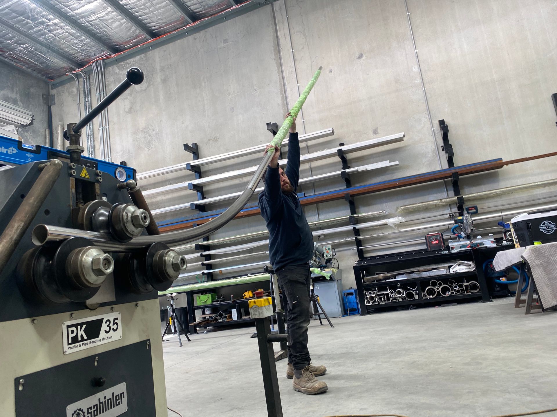 A Man is Standing in Front of a Machine in a Factory — EB Metalworks in Somersby, NSW