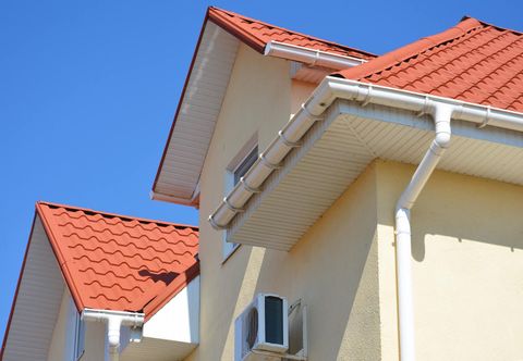 A house with a red roof and a white gutter